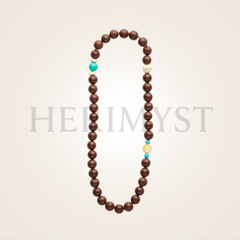 Handcrafted incense bead bracelet by Herimyst. Herimyst Yún Yán incense bead bracelet from the Grace & Ritual Collection, 8 mm double-loop handcrafted beads with turquoise, amber, and ivory accents on a soft neutral background.