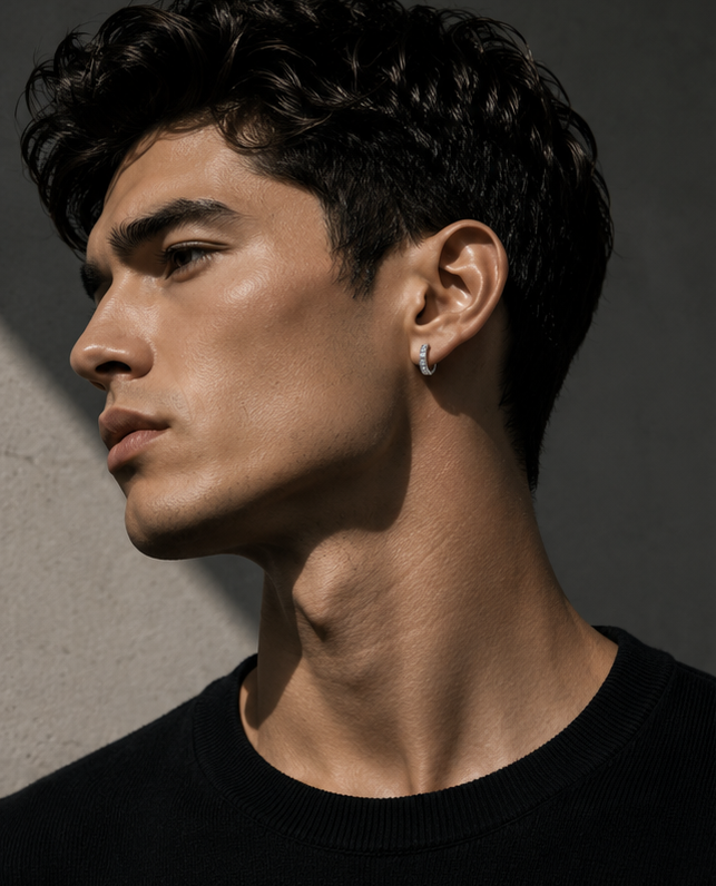 Editorial style portrait of a man wearing a luxury baguette diamond hoop earring in 14K white gold by HERIMYST