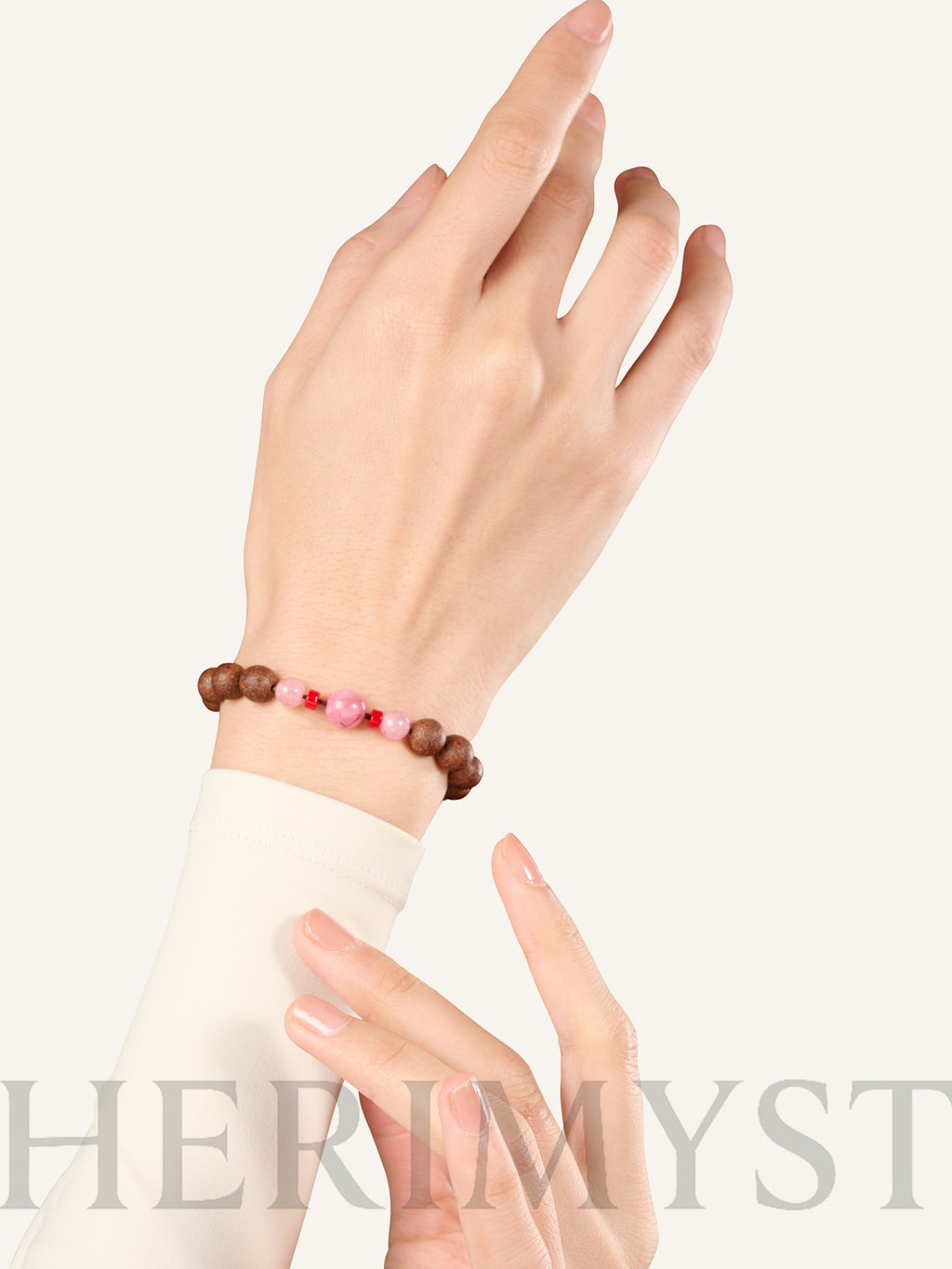 HERIMYST incense bead bracelet worn on wrist, featuring natural wood beads with pink stone accents