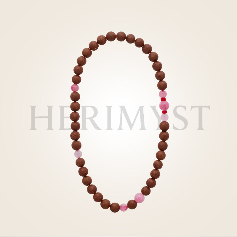 Incense bead bracelet featuring round wooden incense beads accented with pink gemstone beads, arranged in a minimalist oval layout on a light background.