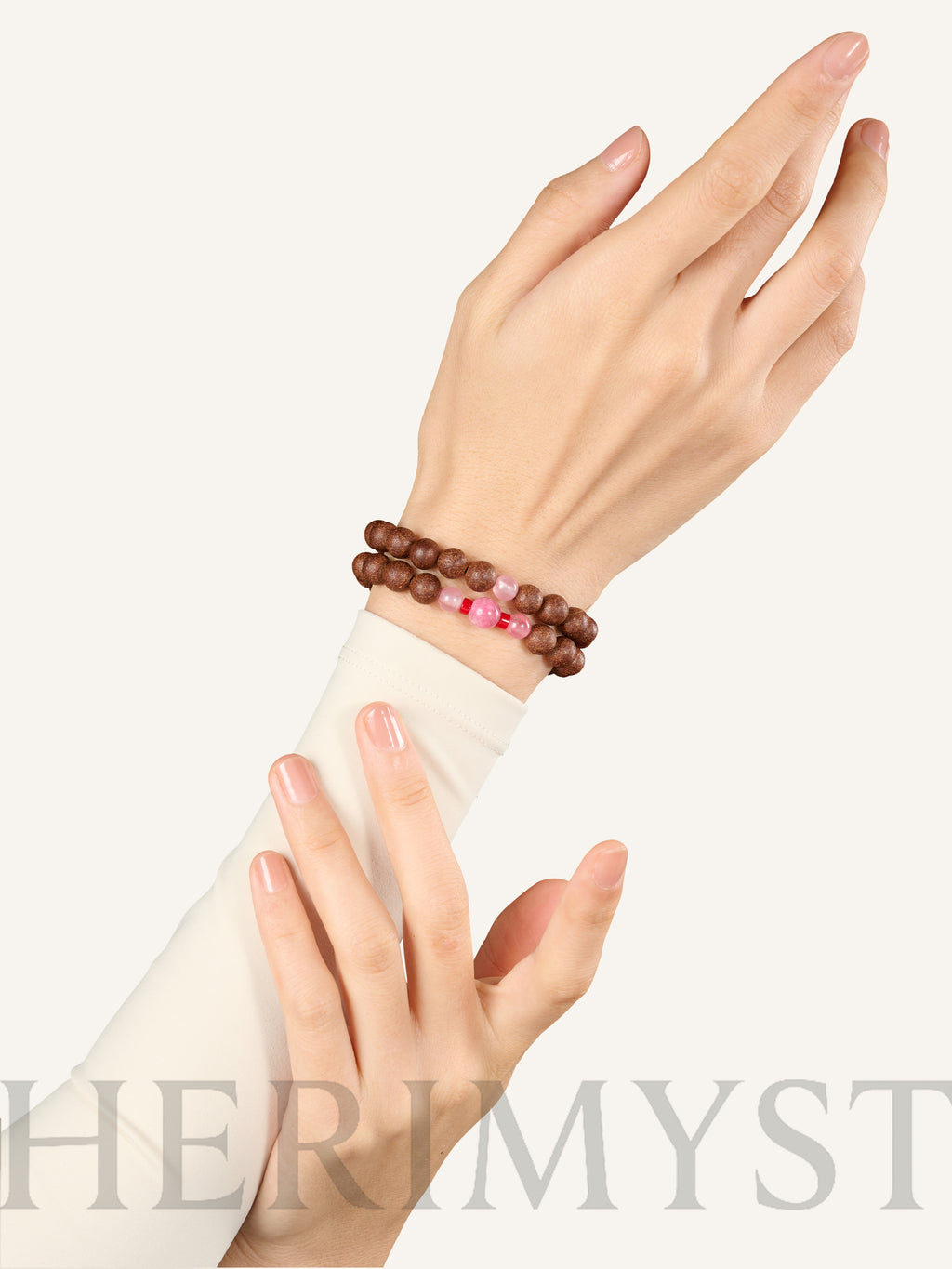HERIMYST incense bead bracelets worn on wrist, featuring natural wood beads with pink stone accents