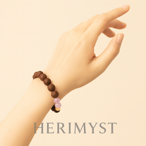 Woman wearing the Herimyst Huān Yán incense bead bracelet from the Grace & Ritual Collection, featuring 10 mm handcrafted incense beads and an amber accent, styled in a calm, minimal setting.