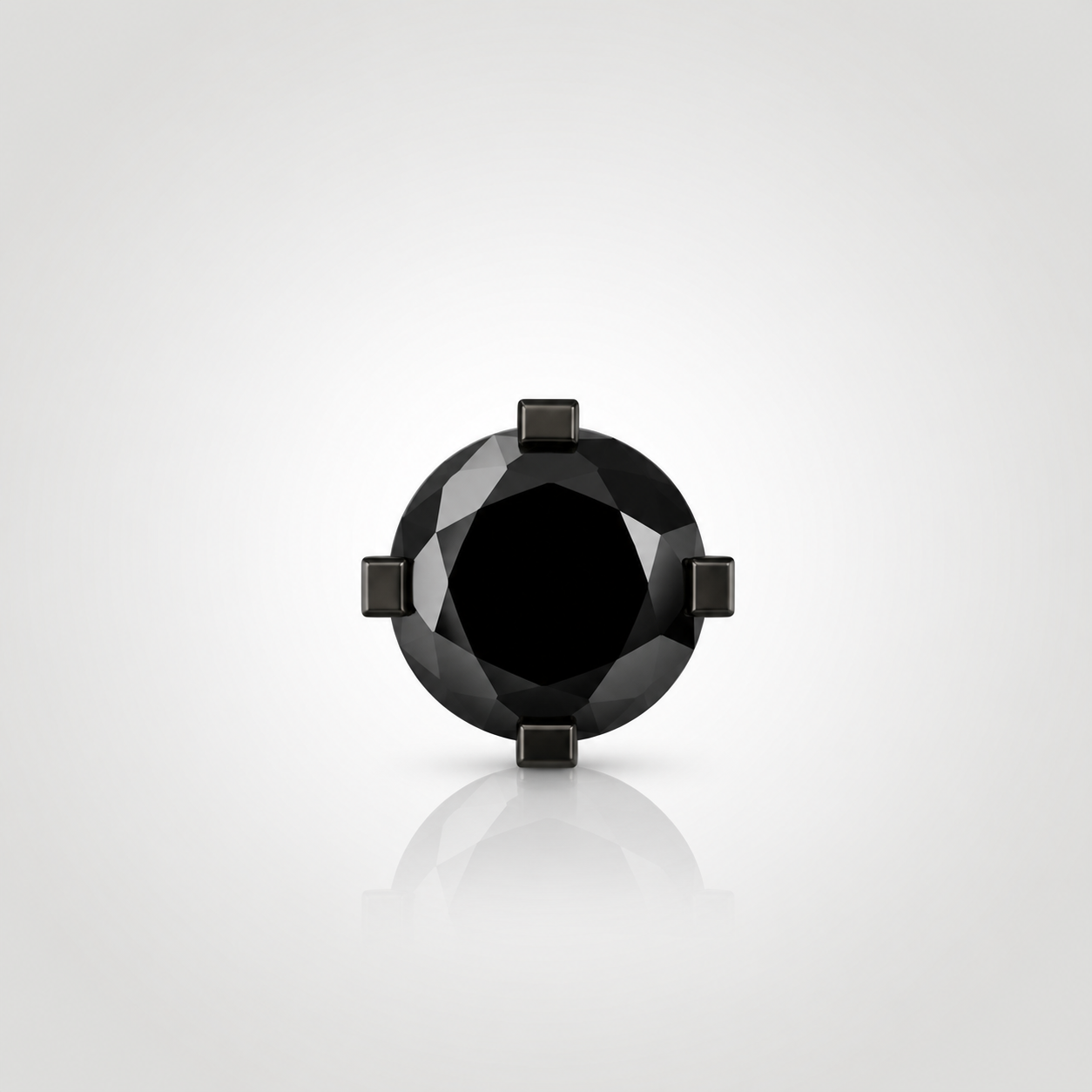 Front view of a natural black diamond stud with geometric four-prong setting in black rhodium-plated 14K white gold