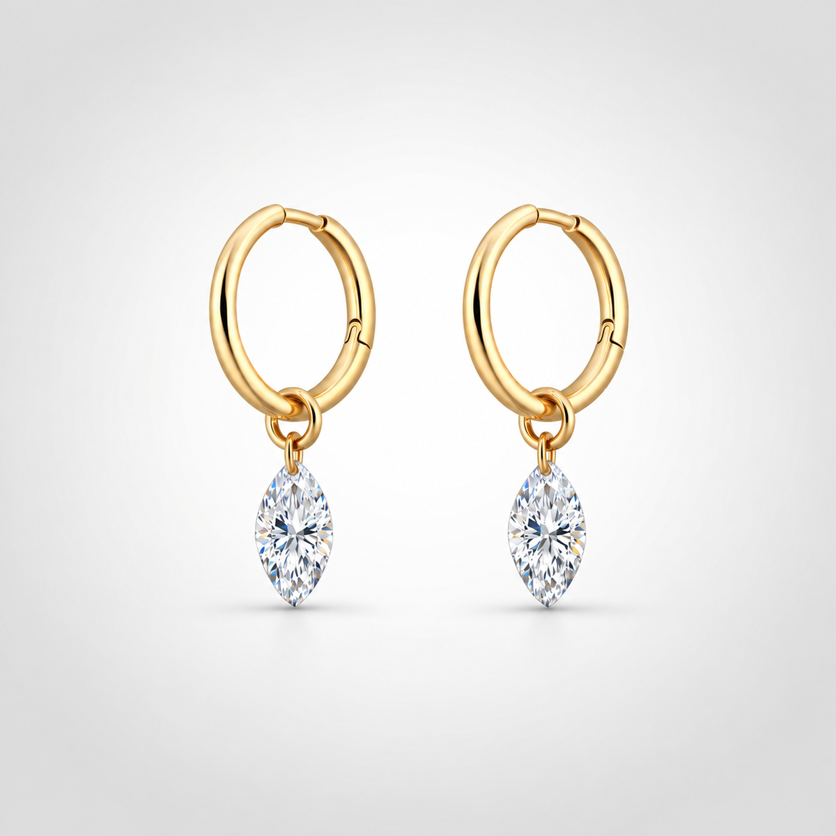Pair of marquise floating diamond drop huggie earrings in 14K yellow gold, featuring lab-grown diamonds with free-moving design