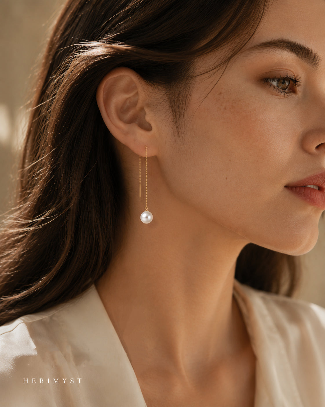 Woman wearing 7.5–8 mm freshwater pearl threader earrings in 14K solid yellow gold