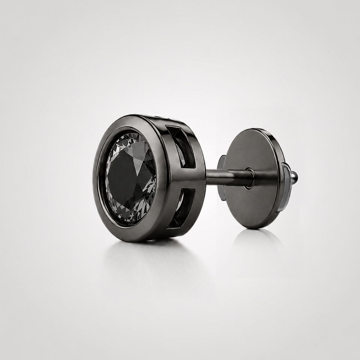 Natural black diamond stud in black-rhodium-finished 14K white gold with a recessed bezel setting and Guardian Back, shown from an angled side view.